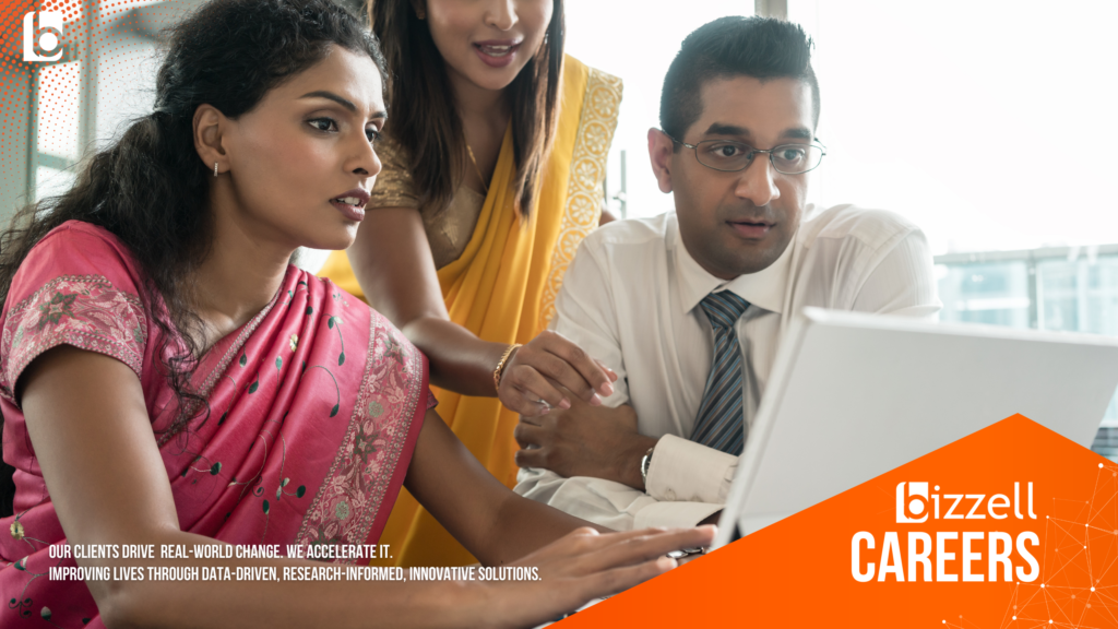 three people looking at a laptop screen